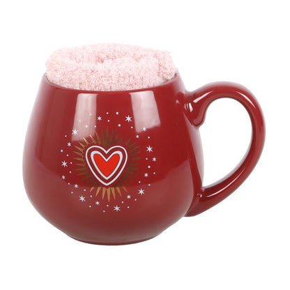 Röd Sacred Heart-mugg med rosa strumpor instoppade